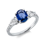 Ring 18 kt WG, 2 Tropfen 0,55 ct, TW-si, 8 Brill. 0,10 ct, TW-pi, 1 Saphir 1,42 ct blau