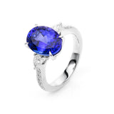 Ring 18 kt WG, 2 Tropfen 0,22 ct, TW-si, 12 Brill. 0,20 ct, TW-si, 1 Tansanit 5,59 ct blau