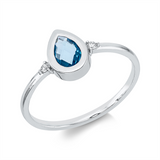 Ring 18 kt WG, 2 Brill. 0,03 ct, TW-si, 1 Topas 0,50 ct blau