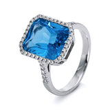 Ring 14 kt WG, 48 Brill. 0,24 ct, TW-si, 1 Blautopas 6,60 ct blau